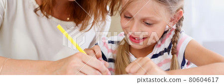Blond little girl hold in arm pencil drawing something Blond little girl hold in arm pencil drawing something 80604617
