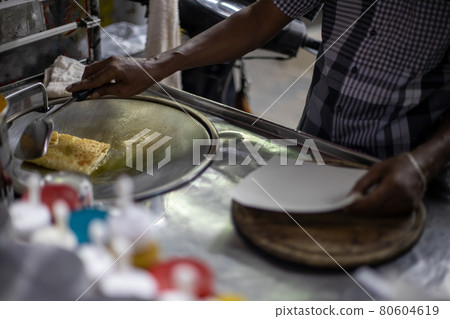 Hands of street vendor cooking Thai style sweet roti. Enjoy street food.. 80604619