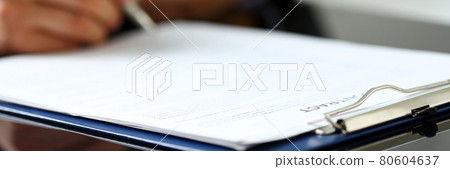 Male arm in suit and tie fill form clipped to pad Male arm in suit and tie fill form clipped to pad 80604637