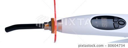 Dental UV lamp for dental fillings closeup Dental UV lamp for dental fillings closeup 80604734