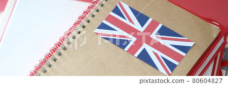 Stylish notepad with britain flag and copybooks on table 80604827
