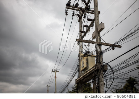 Wires attached to the electric pole, the chaos of cables and wires on an electric pole in asian street. concept of electricity 80604881