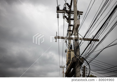 Wires attached to the electric pole, the chaos of cables and wires on an electric pole in asian street. concept of electricity. copy space 80604960