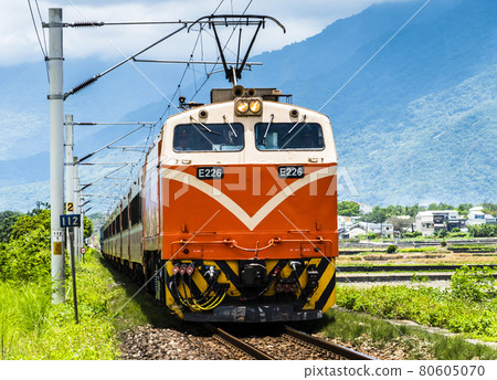 The train is traveling on the tracks in the countryside of Taiwan eastern. 80605070
