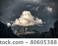 White cloud illuminated by the sun over the top of the mountains during the storm 80605388