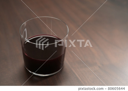 Red wine in tumbler glass on a walnut table with copy space Red wine in tumbler glass on a walnut table with copy space 80605644