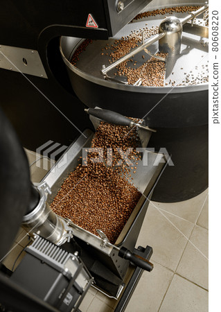 Coffee processing. Roastery, roasting machine and fresh beans 80608220