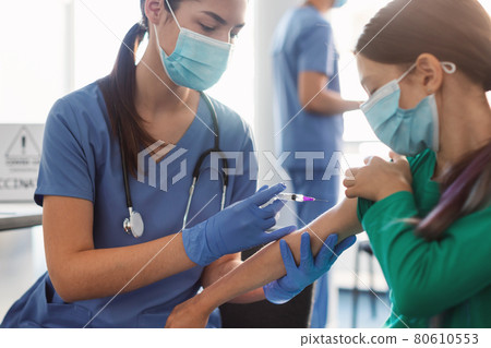 School Girl Receiving Coronavirus Vaccine Injection Sitting With Doctor Indoor School Girl Receiving Coronavirus Vaccine Injection Sitting With Doctor Indoor 80610553