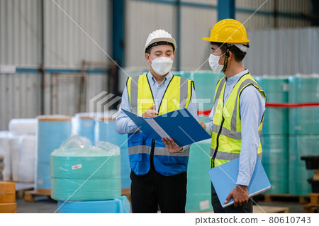 Asian supervisor engineer manufacturing wearing face mask talking for technician. 80610743