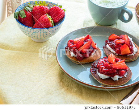 Vegan buckwheat gluten free pancakes breakfast served with chia strawberry jam and dairy free yogurt 80611973