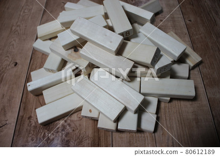 Pile of wooden blocks with engraved letters dispersed on floor. Pile of wooden blocks with engraved letters dispersed on floor. 80612189