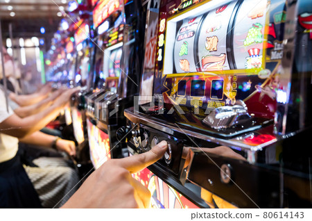 People playing slots at pachinko parlors 80614143