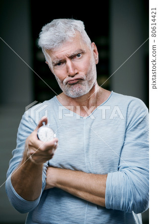 Handsome gray haired senior man with stopwatch in his hand. Sport and health care concept 80614421