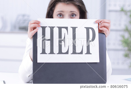 frustrated business woman showing a sheet with the word help 80616075
