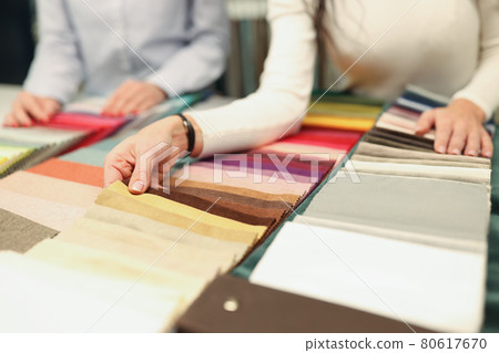 Buyer and seller choose color of fabric closeup Buyer and seller choose color of fabric closeup 80617670