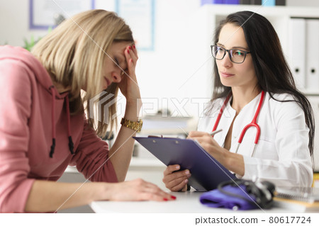 Young woman under stress from medical diagnosis at clinic appointment 80617724