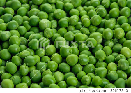 Fresh green pods or peas rotating. Peas background. Top view 80617840