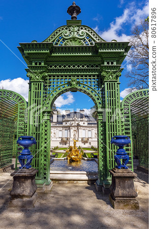 Part of the park with a fountain, arch and sculptures of the Linderhof Palace in Bavaria, Germany Part of the park with a fountain, arch and sculptures of the Linderhof Palace in Bavaria, Germany 80617896