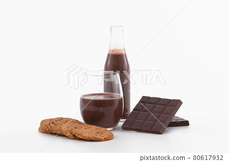 Appetizing bottle and glass of chocolate milkshake with cookies: Selective focus. Chocolate concept 80617932