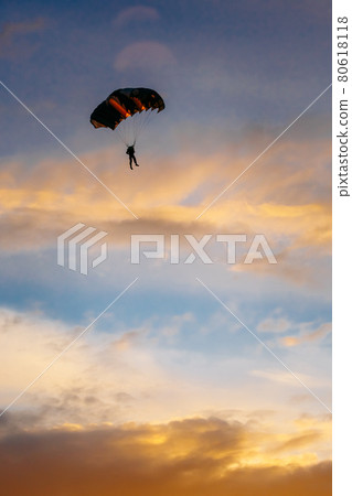 Skydiver On Colorful Parachute In Sunny Sky 80618118