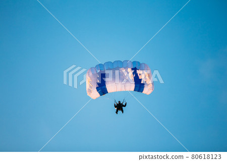 Skydiver On Colorful Parachute In Sunny Sky 80618123