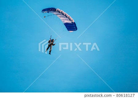 Skydiver On Colorful Parachute In Sunny Sky 80618127