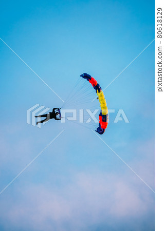 Skydiver On Colorful Parachute In Sunny Sky Skydiver On Colorful Parachute In Sunny Sky 80618129