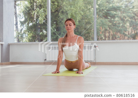 Young woman practicing yoga, doing cobra exercise Young woman practicing yoga, doing cobra exercise 80618516