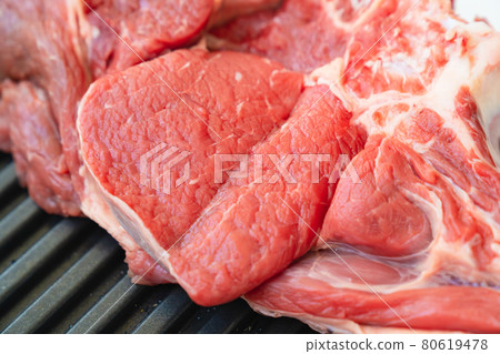piece of beef on bone on black grill pan .natural and eco-friendly farm products 80619478