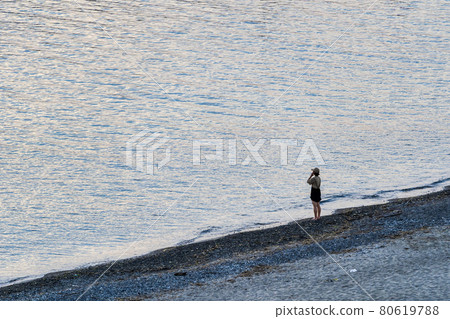 Scenery of the beach Murakami City, Niigata Prefecture, a woman looking at the sea Scenery of the beach Murakami City, Niigata Prefecture, a woman looking at the sea 80619788