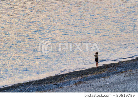Scenery of the beach Murakami City, Niigata Prefecture, a woman looking at the sea Scenery of the beach Murakami City, Niigata Prefecture, a woman looking at the sea 80619789