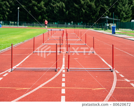 Hurdle on the sprint lane with starting blocks 80620672