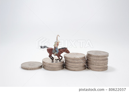 a Mini men riding horse on coin stacks. 80622037