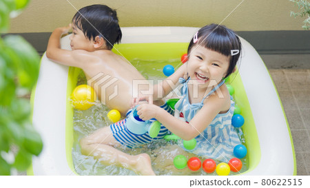 Kids playing in a vinyl pool Kids playing in a vinyl pool 80622515