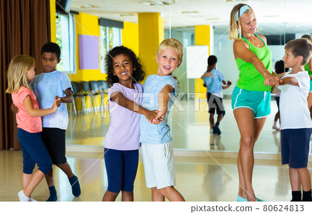 Positive little boys and girls dancing pair dance in the ballet studio Positive little boys and girls dancing pair dance in the ballet studio 80624813