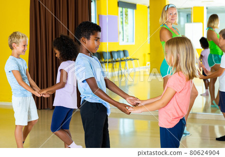 Positive little boys and girls dancing pair dance in the ballet studio Positive little boys and girls dancing pair dance in the ballet studio 80624904