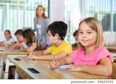 Kids studying in classroom 80625034