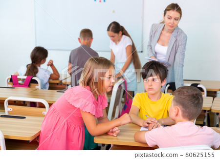 Preteen schoolchilds working in groups at lesson Preteen schoolchilds working in groups at lesson 80625155