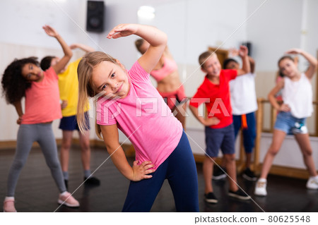 Girl doing stretching exercises before dance training 80625548
