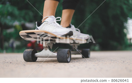Close up asian women surf skate outdoors Close up asian women surf skate outdoors 80626041