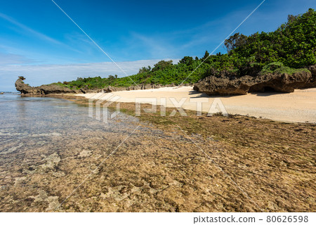 Gorgeous secluded beach, smooth sands, coastal rocks, shallow waters, blue sky. Iriomote Island. Gorgeous secluded beach, smooth sands, coastal rocks, shallow waters, blue sky. Iriomote Island. 80626598