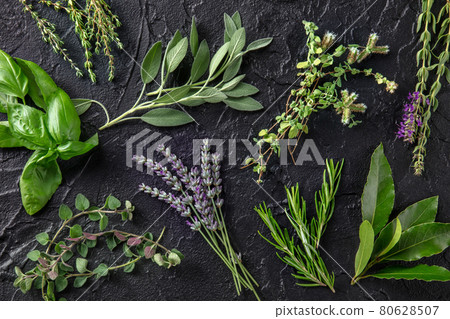 Fresh garden herbs, top shot on a black background. Bunches of herbs 80628507