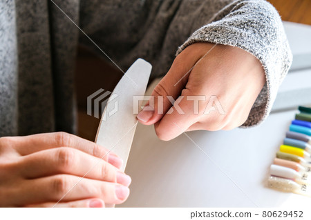 Work at home with nails. Nail care, Self care. Female manicure. Do manicure by yourself while staying at home. Female hands and manicure tools 80629452