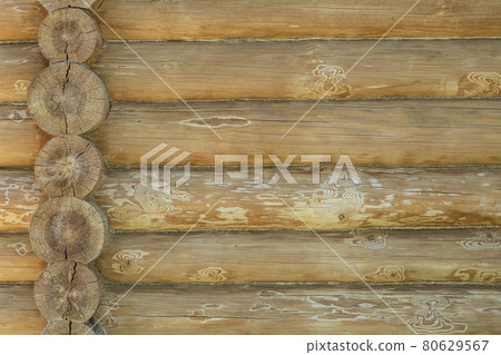 Log house wall background. Construction of a wooden eco-friendly house from natural materials. Pattern and texture of wooden masonry Log house wall background. Construction of a wooden eco-friendly house from natural materials. Pattern and texture of wooden masonry 80629567