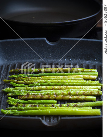 Grilled asparagus. Fried asparagus in a pan. Grilled vegetables on the barbecue. Veg concept 80629897