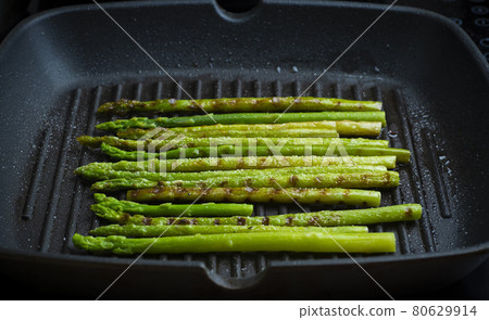 Grilled asparagus. Fried asparagus in a pan. Grilled vegetables on the barbecue. Veg concept 80629914
