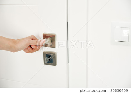 Woman open door and entrance in the room 80630409