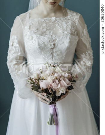 Picture of man and woman with bridal bouquet. Married couple holding hands, ceremony wedding day. Newly wed couple's hands with wedding rings. Picture of man and woman with bridal bouquet. Married couple holding hands, ceremony wedding day. Newly wed couple's hands with wedding rings. 80630840