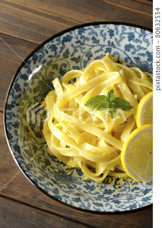 A bird's-eye view of lemon cream pasta with lemon and spearmint cut into slices 80632554