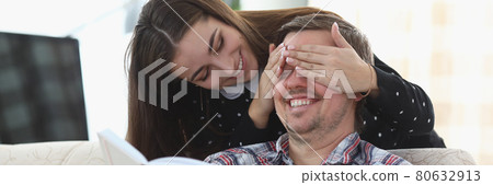 Man is reading book at home. Woman closing his eyes Man is reading book at home. Woman closing his eyes 80632913